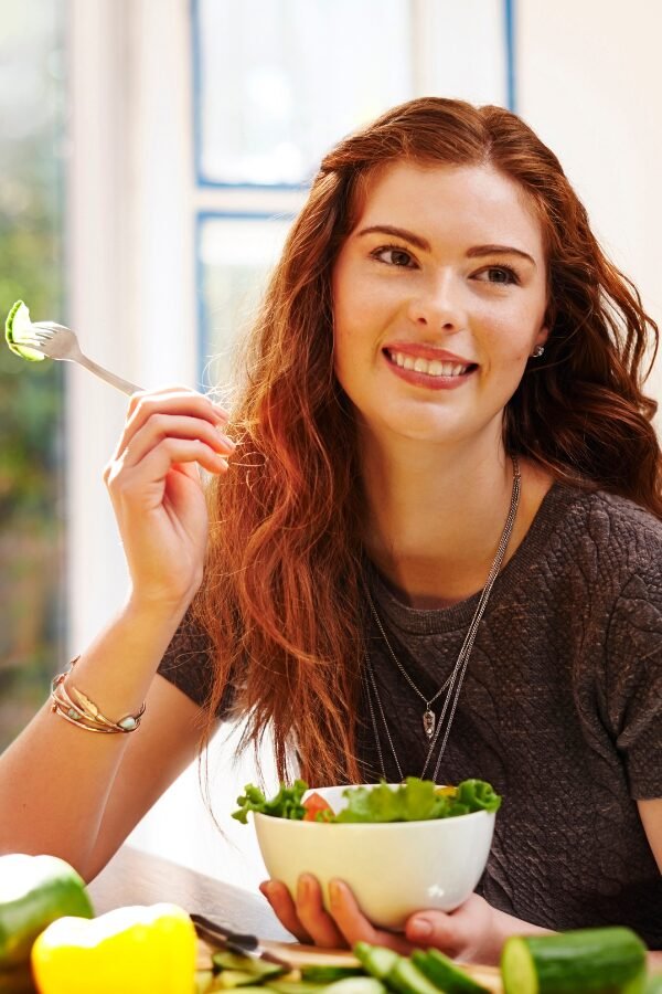 Girl with salad bowl