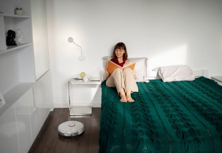 Woman reading peacefully in a minimalist, sunlit modern bedroom.